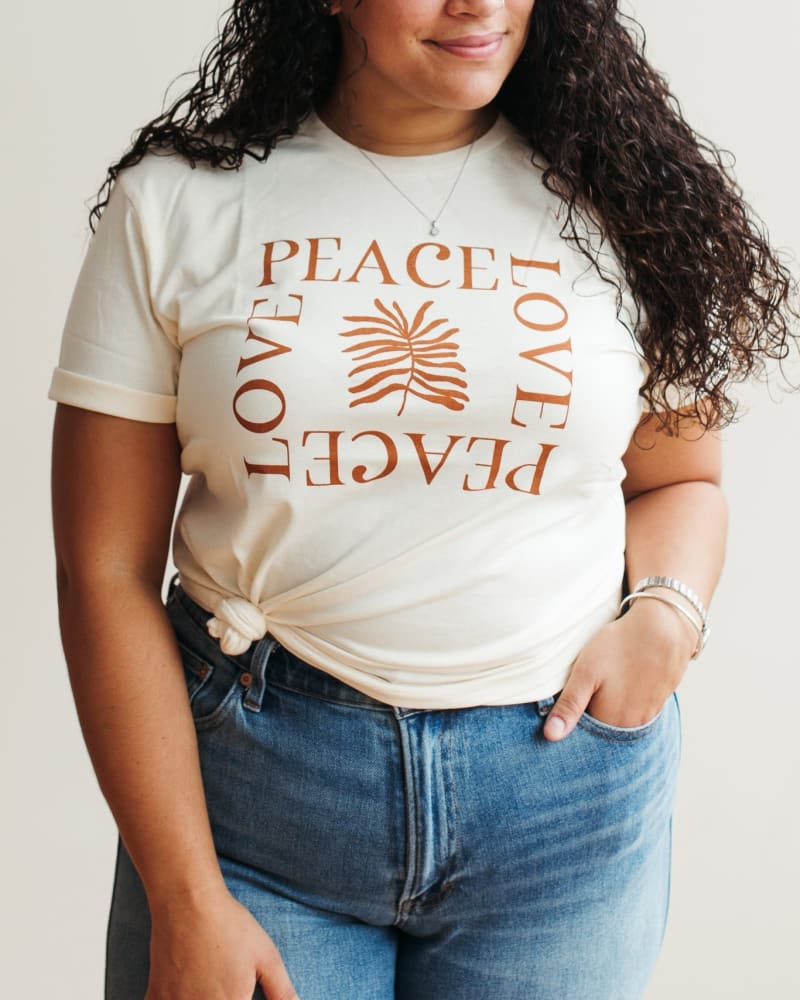 Front of a model wearing a size L Peace Love Graphic T-Shirt in Ivory by Polished Prints. | dia_product_style_image_id:239755